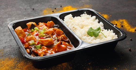 Chinese style chicken with white rice, take-out container. Ready